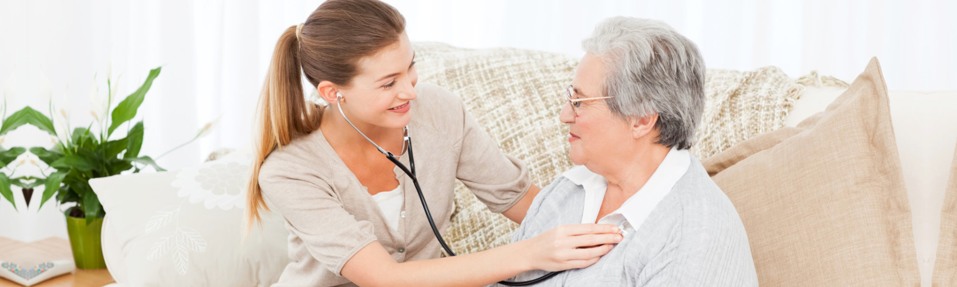 A caregiver examining an elderly